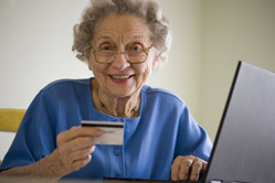 Senior paying for services from online portal at home.