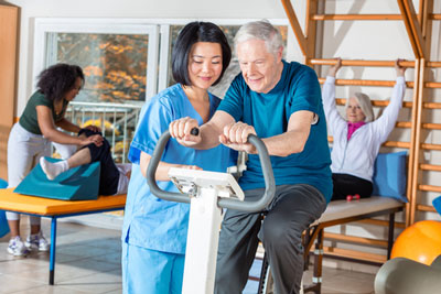 HHA helps elderly man with physical therapy