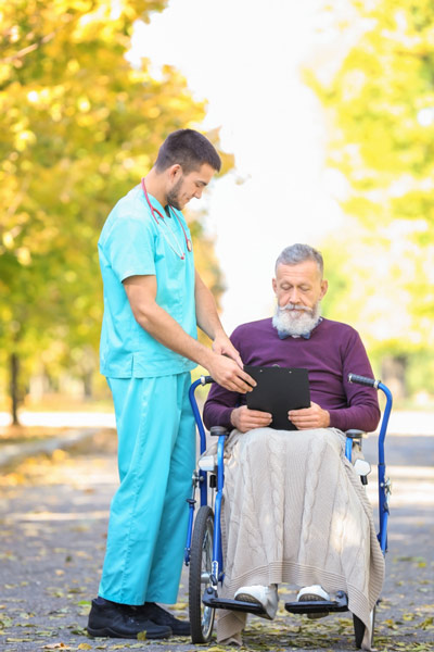 Male home health aide provides senior with assistance