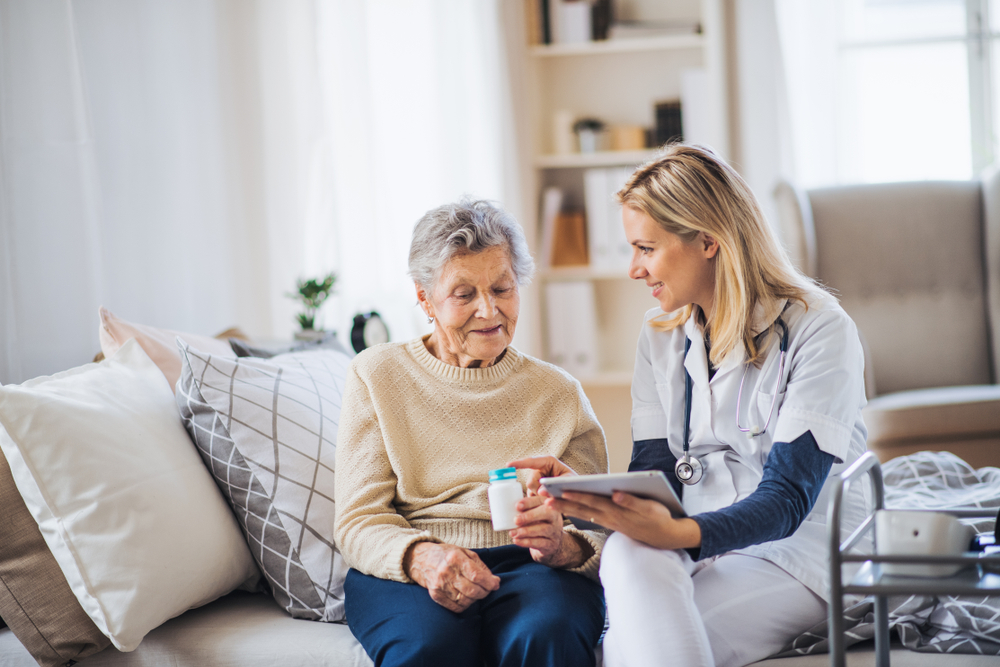 home care aide assisting an elderly female patient